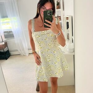 Francesca’s yellow and white patterned linen dress with tie straps.